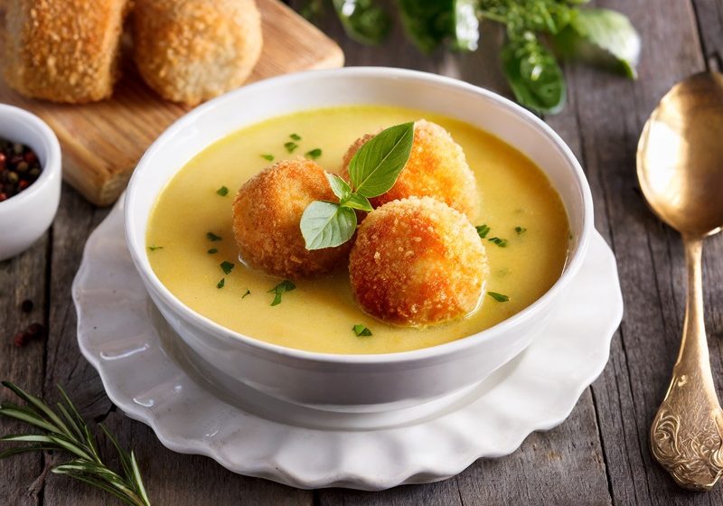 Chicken velouté soup with cheese croquette and truffle